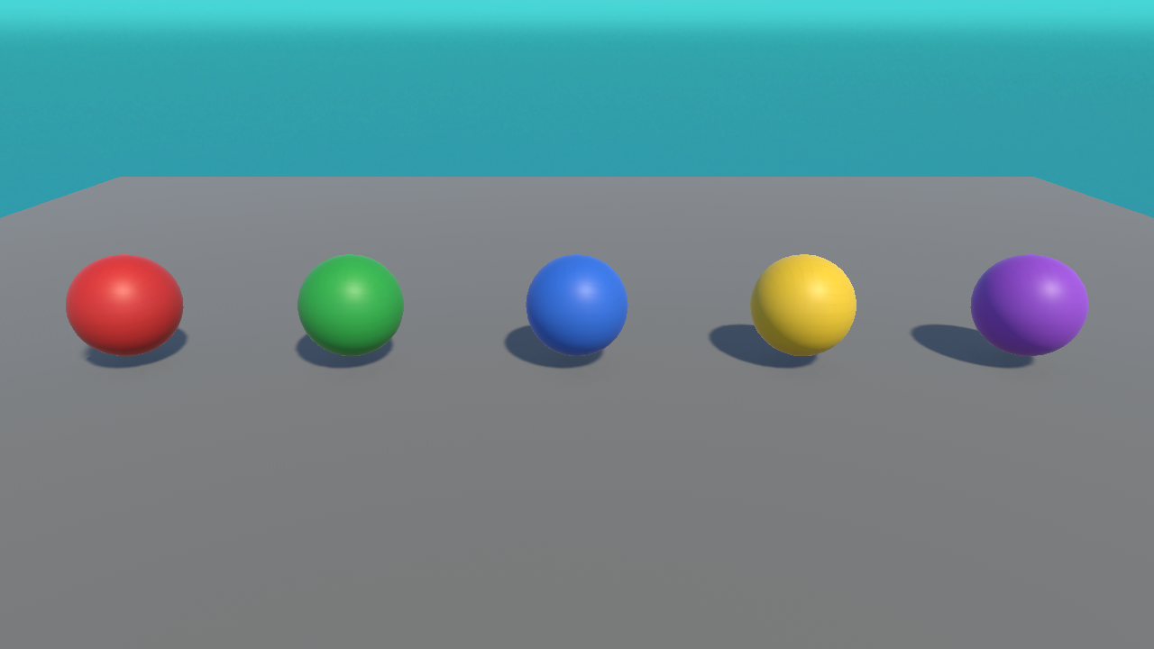 A real Unity render of five spheres with red, green, blue, yellow, and purple materials.