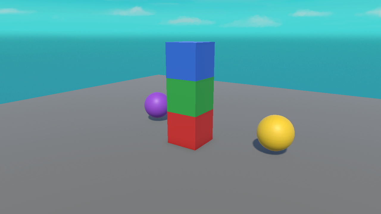 A real Unity render of stacked red, green, and blue cubes and two spheres resting on a floor.