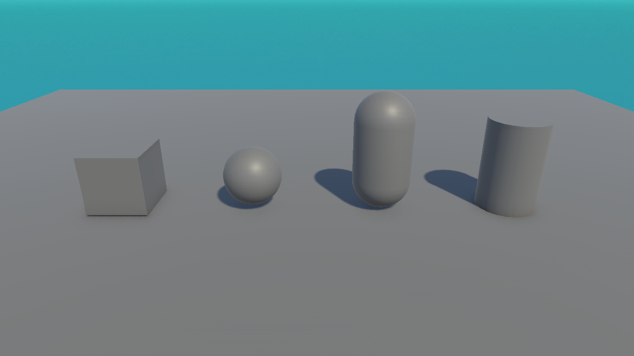 A real Unity render of a cube, sphere, capsule, and cylinder on a floor.